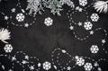 Christmas background: white snowflakes and garland on the black background. Top view. Flat lay Royalty Free Stock Photo